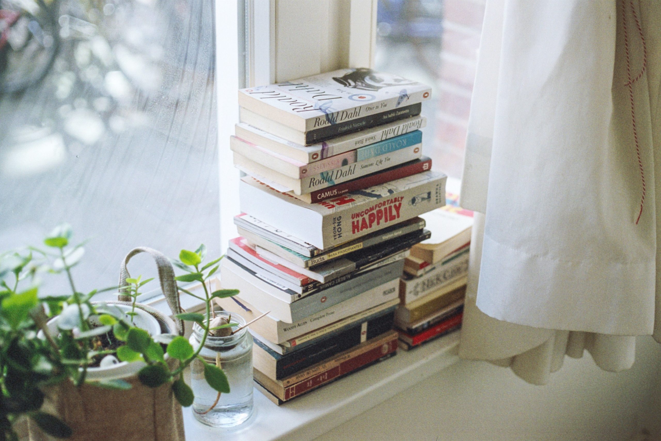 books stacked on a windowsill