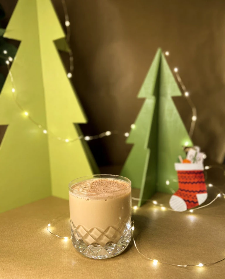 baileys martini cocktail in a rocks glass in front of a festive background